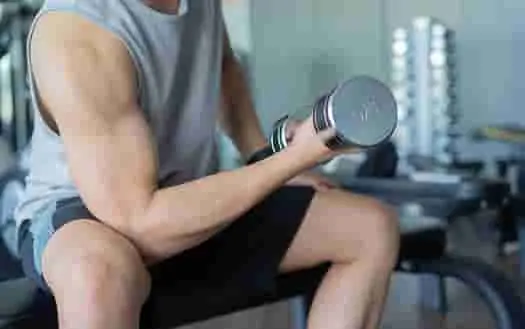 hombre levantando pesas en gimnasio